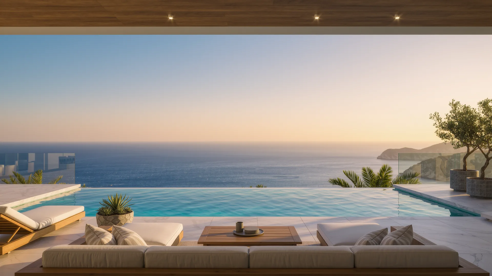 Terraza de villa moderna con piscina infinita sobre el Mediterráneo al anochecer